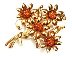 For your consideration is this vintage flower brooch. It consist of a stamped metal with a golden copper coating on it. the flowers are made of  orange color  cabochon. The dimension of this large  flower pin is 3 inches x 2 1/2 inches it is in good vintage condition. Thank you very much for stopping by . Please feel free to email (CONVO) me with any questions or concerns. Click here to return to my shop and explore more treasures https://serendipitytreasure.etsy.com Mid Century Floral, Golden Copper, Stamped Metal, Jewelry Brooch, Floral Pins, Flower Spray, Antique Brooches, Diamond Rings Bands, Gold Flower