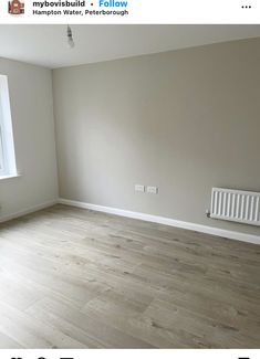 an empty room with white walls and wood flooring is featured in this postcard