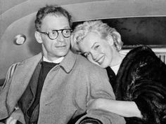 a man and woman sitting next to each other in a car, posing for the camera