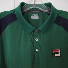 Fila Mens S/S Green Golf Tennis Polo Shirt. Size Large*. Armpit-To-Armpit 24", Length 30". 100% Polyester In Green/Navy. *Labeled "Xl" However Measurement & Actual Fit More Appropriately "Large". New W/O Tags, Suitable For Gifting. Classic Green Sports Tops, Classic Green Sports Top, Green Sporty Polo Collar Shirt, Sporty Green Golf Shirt, Green Polo Collar Tops For Golf, Green Cotton Golf Tops, Green Cotton Tops For Golf, Green Cotton Golf Shirt, Casual Green Tops For Golf