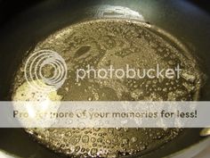 a frying pan filled with lots of oil and water on top of a stove