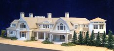 a model of a large white house with trees on the front and back sides,