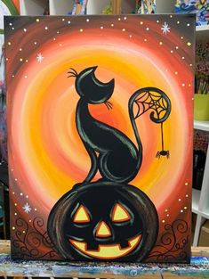 a painting of a black cat sitting on top of a jack - o - lantern