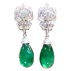 A pair of exquisite earrings boast a classic design that exude timeless elegance. The Emeralds , with their verdant green hue , captivate the eye with their vibrant brilliance . Nestled amongst the emeralds are glistering diamonds , which add a touch of glamour and luxury to the piece. Every detail is carefully crafted to perfection , making these earrings a true treasure to behold. Magnificent earrings come in 18k gold with 2 pieces of adorable Natural Zambian Emeralds, in perfect cabochon cut, spectacular vivid color, fine quality, only Minor treatment, of 50,00 carats, and 264 pieces of Natural Diamonds, of 2,60 carats, F-G color VS clarity. Handcrafted by artisan goldsmith. Complete with AIG report. Wholesale Price. Extremely HIGH QUALITY Product. Earring Video, Verdant Green, 18k Gold Earrings, Zambian Emerald, Emerald Stone, Vivid Color, Modern Earrings, Modern Jewelry, Chandelier Earrings