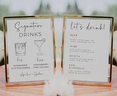 two menus with drinks on them sitting on a table