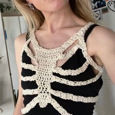 a woman wearing a black and white crochet top