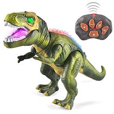 a toy dinosaur with its mouth open next to a remote control device that is connected to it's paw