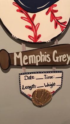 a baseball themed sign hanging on the side of a wall that says, memphis grey date time length weight weight