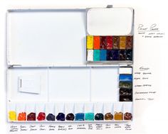 an artist's watercolor palette with its contents labeled on the bottom and inside