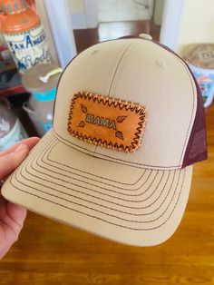 Made to order tooled leather MAMA patch cap! Cap colors are khaki and maroon! Adjustable Brown Leather Baseball Cap, Brown Baseball Cap With Embroidered Logo, Brown Snapback Baseball Cap With Embroidered Logo, Casual Brown Baseball Cap With Letter Patch, Brown Flat Bill Trucker Hat With Logo Patch, Brown Snapback Hat With Embroidered Logo And Flat Bill, Brown Leather Patch Baseball Cap With Flat Brim, Brown Snapback Hat With Embroidered Logo, Brown Embroidered Snapback Hat