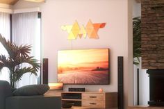 a living room filled with furniture and a large flat screen tv mounted on the wall