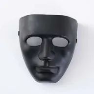 a black mask hanging on the wall