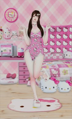 a girl in a pink hello kitty swimsuit is standing on her bed and posing for the camera