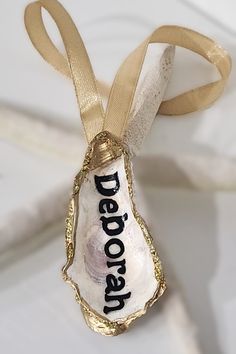 an ornament hanging from a ribbon with the word deadwood on it's side