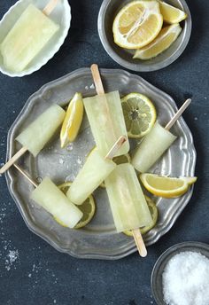 some food is on a plate with lemons and toothpicks in the middle