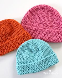 three crocheted hats sitting next to each other