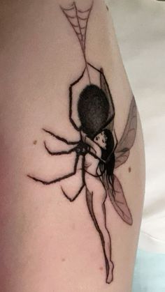 a woman with a spider tattoo on her arm