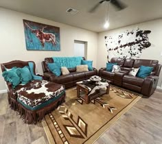 a living room with couches, chairs and rugs on the floor in front of a painting