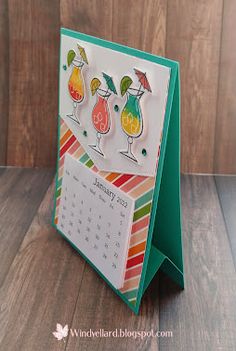 a card with three cocktail glasses on it, and the calendar is in front of it