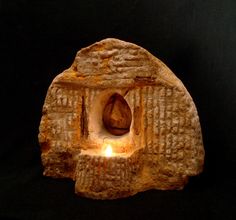 an ancient object with a lit candle in it