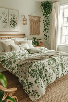 a bed with green leaves on it in a bedroom next to a window and wicker chair