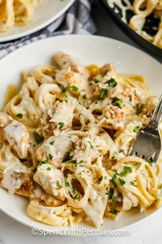 pasta with chicken and parmesan sauce in a white bowl on a marble table