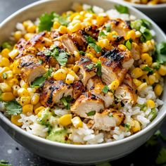 a bowl filled with rice, corn and cilantro on top of a table