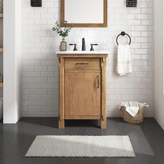 a bathroom with a sink, mirror and rug on the floor in front of it