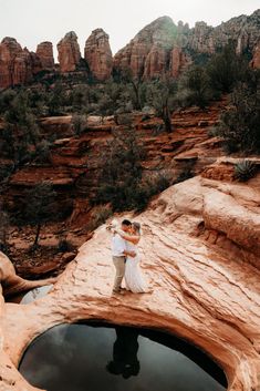 a bride and groom standing on the edge of a cliff in sedona, arizona