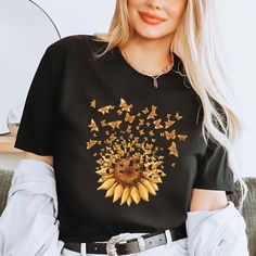 Sunflower Butterfly Shirt, Flower T-Shirt, Butterfly Tee, Floral Mothers Day Gift Tee, Mom Shirt, Womens Shirt, Trendy Shirts, Aesthetic Tee 👉HOW TO ORDER👈 1️⃣ Please review all the information provided before placing an order 2️⃣ Select the shirt type and size using the drop down menu. 3️⃣ Select the color of the shirt using the following drop down menu. 4️⃣ Need more Items? Add the current item in the cart. And If you like to add more items to your order please press the back button and repeat steps 1-3 again. 5️⃣ Once all your desired items are in your cart you may complete your order by entering your payment method, desired shipping address and click submit. 👉SIZING👈 If you are unsure about the size you should order, please refer to the size chart in the pictures. 👉PROCESSING TIME Black T-shirt With Sunflower Print For Spring, Black Graphic Tee With Floral Print, Black Graphic Tee Shirt With Floral Print, Black Floral Print Graphic Tee Shirt, Black T-shirt With Floral Print For Fall, Spring Black T-shirt With Sunflower Print, Black Crew Neck Shirt With Floral Print, Fall Yellow Printed T-shirt, Yellow Printed T-shirt For Fall