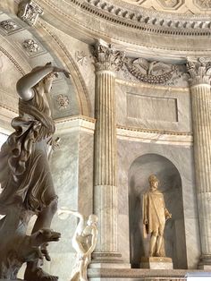 two statues in the middle of a building