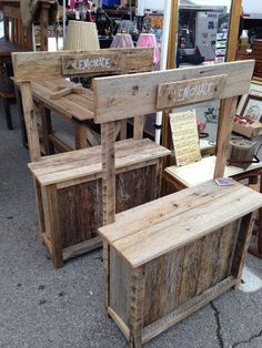 several wooden benches and tables on display at an outdoor market