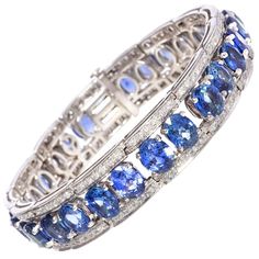 The blue sapphire bracelet features calibrated oval cut faceted Ceylon sapphires of splendid color for a total of approximately 35 carats. The design is complete with approximately 2 carats of top quality diamonds (color, clarity and cut, F/G-VVS). The bracelet was handmade by maestro Salvatore in 18 carat white gold in our own workshop in Italy, according to an original design by Ella Gafter. The item is signed EG. It is shown with LU80239204252 in the last image of the carousel. Ella Gafter on Luxury Traditional Blue Cuff Bracelet, Argentium Silver Jewelry, Blue Sapphire Bracelet, Diamond Cuff Bracelet, Silver Tennis Bracelet, Flexible Bracelet, Sapphire Wedding, Sapphire Bracelet, Argentium Silver