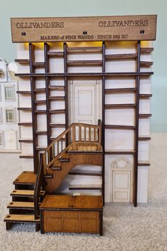 a doll house with stairs and furniture in front of the entrance to an old - fashioned building