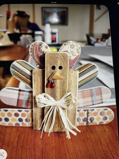 a wooden turkey sitting on top of a table