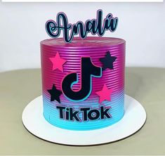 a pink and blue birthday cake with the number five on it's top is decorated with stars