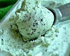 a scoop of ice cream sitting on top of a metal tray next to a green towel