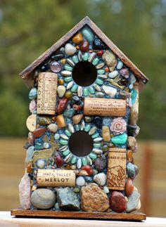 a bird house made out of rocks and wine corks