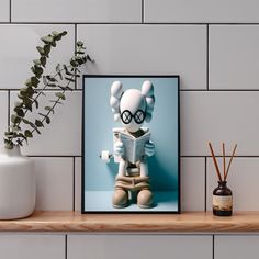 a framed photograph of a cartoon character on a shelf next to a potted plant