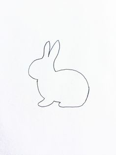 a drawing of a rabbit sitting on top of a white sheet with the outline of it's head