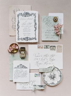 the wedding stationery is laid out on top of each other