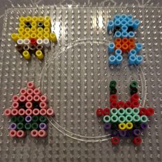 three different colored beads sitting on top of a plastic tray with an object in the middle