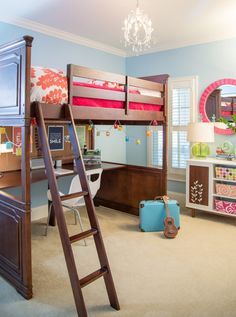 a child's bedroom with bunk beds, dressers and a desk in the corner