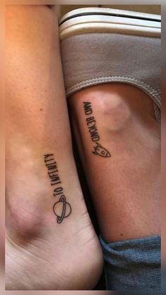 two people with matching tattoos on their legs, one is holding the other's leg