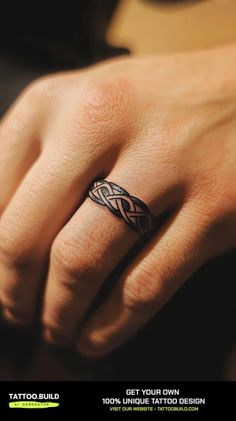 a woman's hand with a tattoo ring on her left wrist and the words get your own design