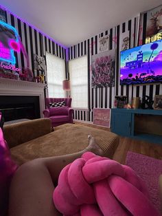 a living room decorated in pink and black stripes