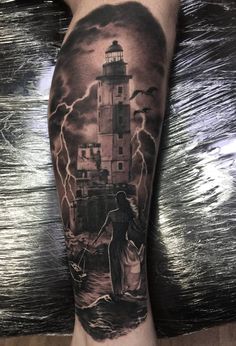 a man's arm with a lighthouse and storm coming in from the ocean on it