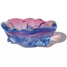 a blue and pink bowl sitting on top of a table