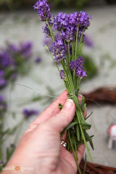 someone is holding some flowers in their hand