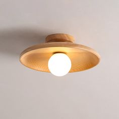 a light that is on the ceiling with a white wall in the backround